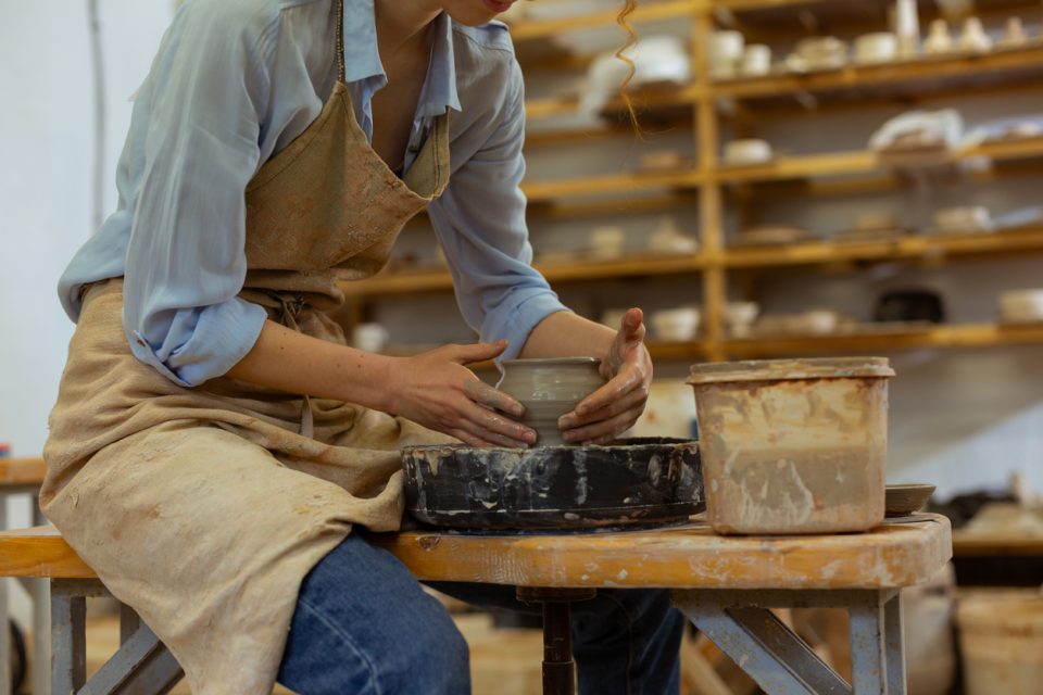 Adult taking a pottery class.