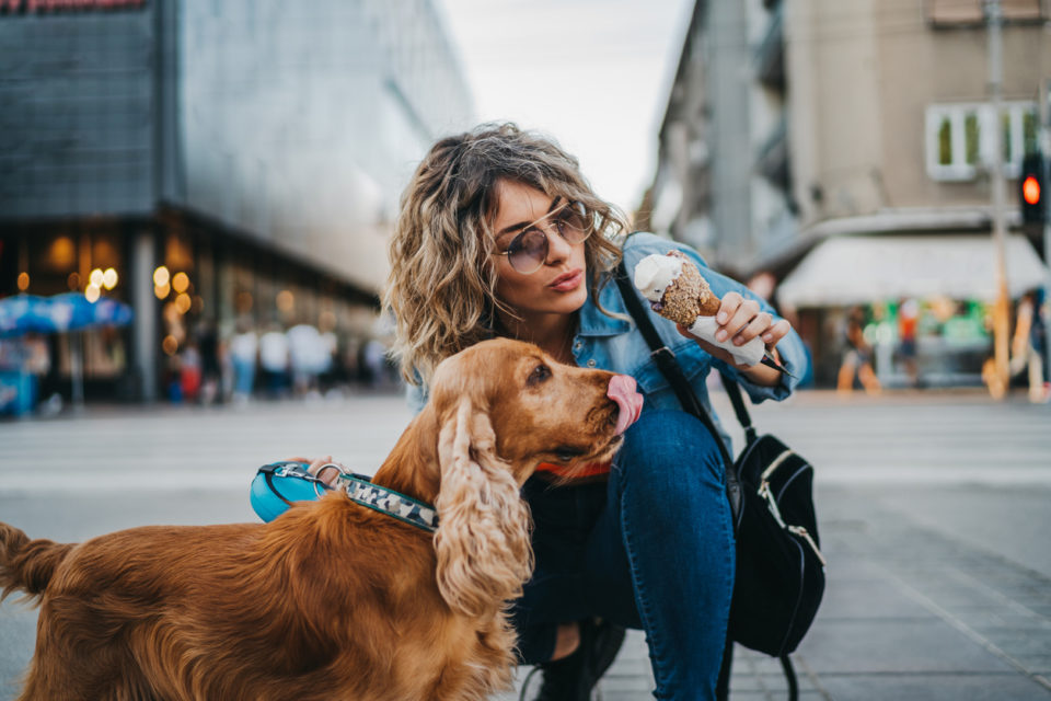 woman and her dog sharing vanilla ice cream