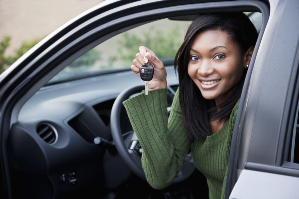 young teenage driver holding car keys
