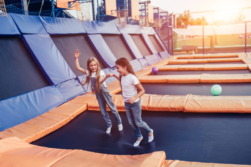 kids jumping at an outdoor trampoline park
