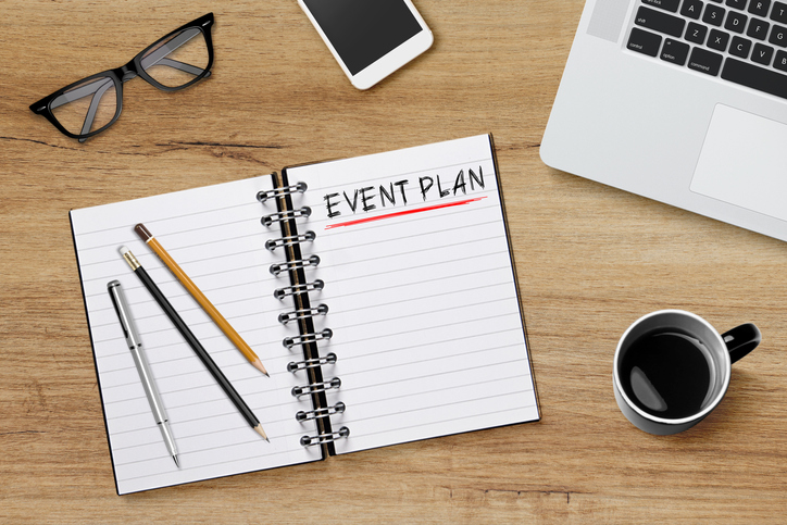 Event planing text on notebook with modern workplace